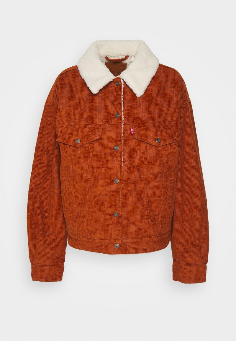 Hnědo-oranžová kordurová bunda s bílým kožešinovým límcem, předními patentkami a dvěma náprsními kapsami. Texturovaná látka s vertikálními žebry.