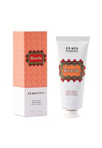 Handcreme in einem weißen Schlauch mit Schraubverschluss, verziert mit bunten Blumenakzenten und einem dekorativen Etikett. Enthält eine gemusterte Pappschachtel.