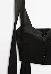 Black satin corset top with structured cups, adjustable shoulder straps, and button detailing down the front. Smooth texture throughout.