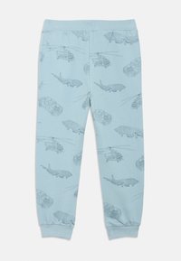Light blue cotton joggers featuring an all-over print of outlined vehicles, including helicopters and cars, with fitted cuffs at the ankles.