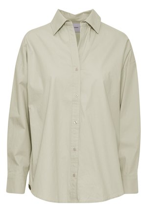 Svetlozeleni srajčni zgornji del, izdelan iz mehkega in gladkega materiala. Ima klasičen ovratnik, dolge rokave in rahlo ukrivljen rob.