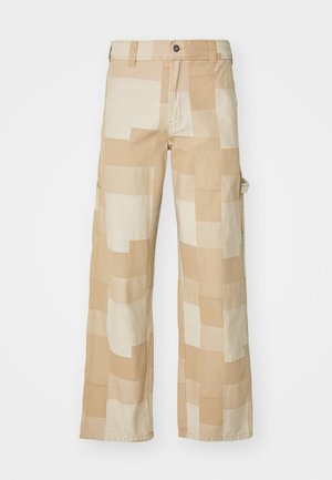 Beige cargo pants featuring a geometric patchwork design with various shades of cream. Made of durable fabric with side pockets.