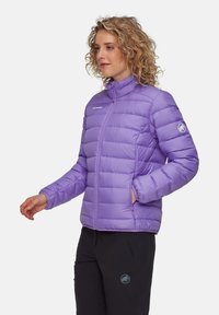 Lys lilla isoleret jakke med høj krave, quiltet design, sidelommer og logo på ærmet, fremstillet af Pertex-materiale.