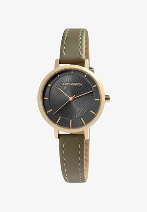 Round black watch face with gold markers and hands, "Just Watch" logo, gold case, and olive green leather strap with white stitching.