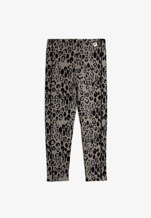 Damskie legginsy slim fit w czarny leoparda wzór na szarym materiale, metka o średnim rozmiarze na pasie.