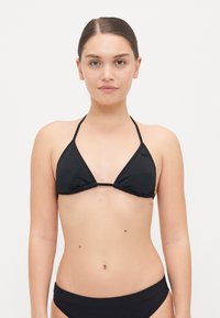 Black triangle bikini top made of stretchy material, featuring thin halter straps and gathered detailing along the edges.