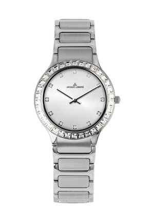 Silberne Armbanduhr mit Metallarmband, kristallbesetzter Lünette, minimalistischen Zifferblattmarkierungen und drei schwarzen Zeigern, die 9:14:08 anzeigen.