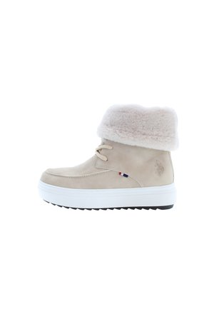 Beige suede ankle boot with faux fur cuff, cream laces, and white sole. Features a logo accent and textured tread for grip.