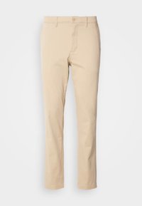 Pantaloni in cotone beige con vestibilità dritta, dotati di chiusura con bottone frontale e tasche. Tessuto morbido e design semplice.