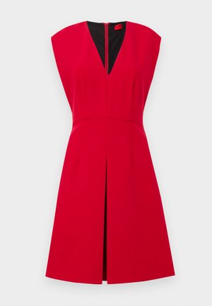 Red sleeveless dress with a deep V-neck, zipper closure at the back, and a flared skirt with front pleats. Smooth fabric and structured design.