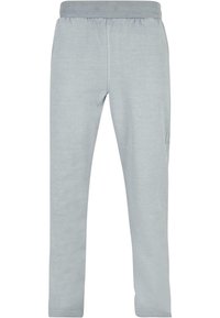 Ljusgrå sweatpants gjorda av mjukt tyg, med elastisk midja, tapered bendesign och sidoficka. Slät textur genom hela plagget.