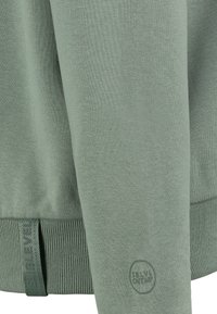 Grüne Sweatshirt mit gerippten Bündchen und Saum, aus einem strukturierten Stoff und mit einem Logostempel am Ärmel. Leicht und lässig im Design.