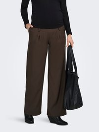 Brown wide-leg trousers with front pleats and side pockets, paired with a fitted black long-sleeve top and black wedge boots.