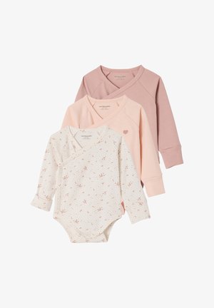 Three long-sleeve baby bodysuits with crossover necks, in white floral print, solid pale pink with heart, and muted mauve colors.