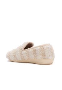 Beige fluffig halkskydd med mjuk gummisula, texturerad med fluffigt, lockigt tyg för inomhuskomfort.
