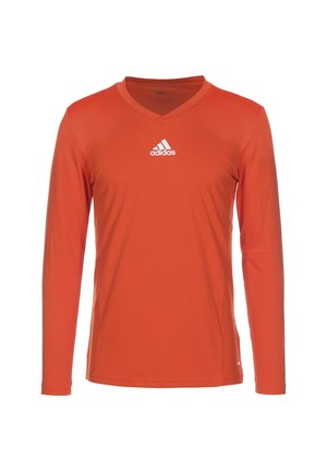 Langarm, V-hals, sportshirt van helder oranje stof. Bevat een wit Adidas-logo op de borst. Gladde textuur met een lichte glans.