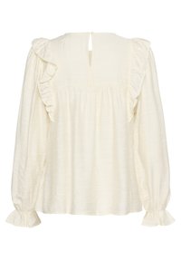 Top a maniche lunghe color crema con dettagli arricciati sulle spalle e sui polsini, caratterizzato da una chiusura a cullo sulla schiena e una texture a pieghe nel corpo.