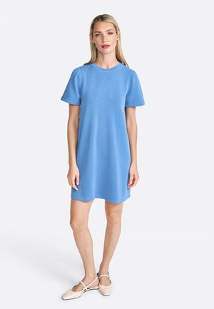 Light blue short-sleeve dress, soft fabric, relaxed fit, rounded neckline, slightly puffed sleeves, hem falls above the knee, worn with light shoes.