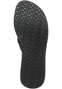 Zwarte rubberen sandaalzool met een gestructureerd grippatroon met ovale vormen, ontworpen voor tractie en duurzaamheid.