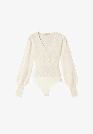 Body in pizzo color crema con maniche lunghe, scollo a V, vita arricciata, maniche a sbuffo e polsini aderenti.