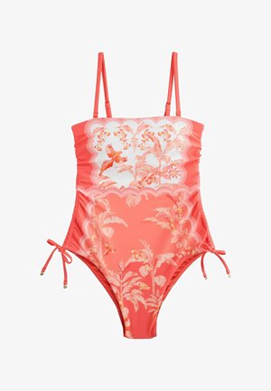 Koralų spalvos vientisas maudymosi kostiumėlis su reguliuojamomis petnešėlėmis, gėlių ir paukščių raštu, banguotais kraštais ir šoninėmis raištelėmis klubų srityje.