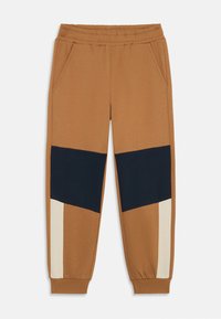 Braune Sweatpants mit navy- und cremefarbiger Blockgestaltung, ausgestattet mit Seitentaschen und elastischen Bündchen für einen eng anliegenden Sitz. Hergestellt aus weichem, atmungsaktivem Material.