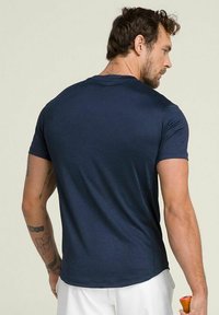 Camiseta de manga corta azul marino hecha de tela suave, diseño ajustado con cuello redondo, sin patrones ni acentos visibles.