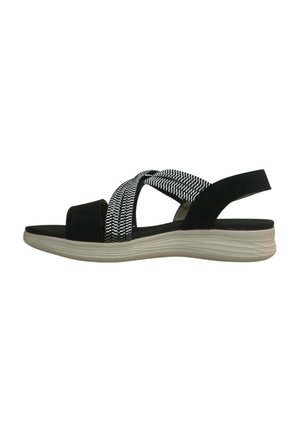 Black and white women's sandal with elastic crisscross straps and cushioned beige sole, open toe and back strap design.
