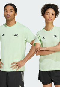 Light green cotton t-shirts with short sleeves and black AR logo, paired with black shorts featuring white striped accents.