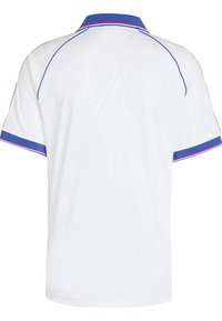 Biela polo tričko s modrým a červeným lemovaním okolo goliera a rukávov. Na zadnej strane má jemný vzor. Krátke rukávy.
