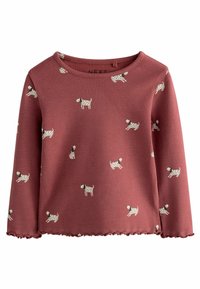 Długi rękaw ribbed top w kolorze burgundowym z falbanką u dołu. Posiada zabawny nadruk z psem w kolorze kremowym, podkreślający miękką teksturę i luźny krój.