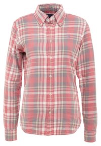 Rutig skjorta med knäppning i rosa, grått och krämfärgat. Har en krage, långa ärmar och knappar fram med kontrasterande tygtextur.