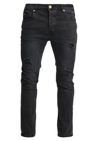 Vaqueros de mezclilla negra con ajuste slim, que presentan detalles desgarrados en los muslos y las rodillas, cinco bolsillos y un botón dorado de cierre.