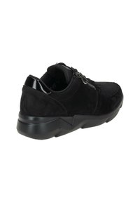 Black sneakers featuring a mix of suede and mesh material, rounded toe, chunky sole, and zipper detail on the side for easy access.