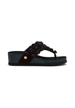 Tongs noires avec une sangle texturée ornée d'ornements floraux, une semelle compensée basse et un accent circulaire doré.