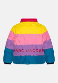 Färgglad pufferjacka med horisontella ränder i gult, rosa, lila och teal, med "MARC JACOBS" logo över ryggen.