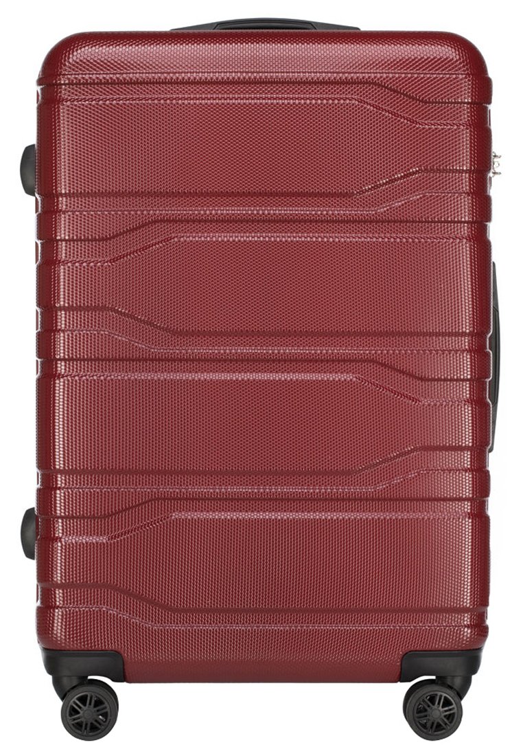 Valise rigide rouge avec surface texturée, dotée d'un design épuré, d'une poignée réglable et de quatre roues pivotantes pour plus de mobilité.