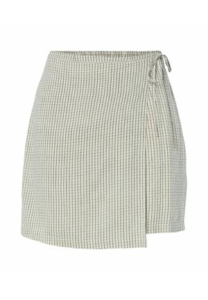 Jupe portefeuille beige clair avec un fin motif quadrillé noir et une fermeture à nouer sur le côté, longueur au-dessus du genou, coupe droite.