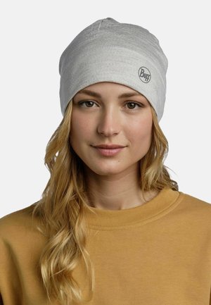 Gray fabric beanie with a smooth texture and seam detailing, featuring a small black circular logo on the front.