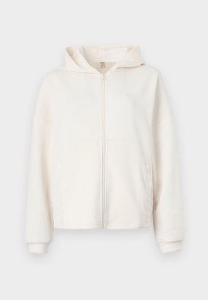 Kremfarvet zip-up hoodie lavet af blødt stof, med en frontlomme, ribbede cuffe og logo-detalje på brystet.