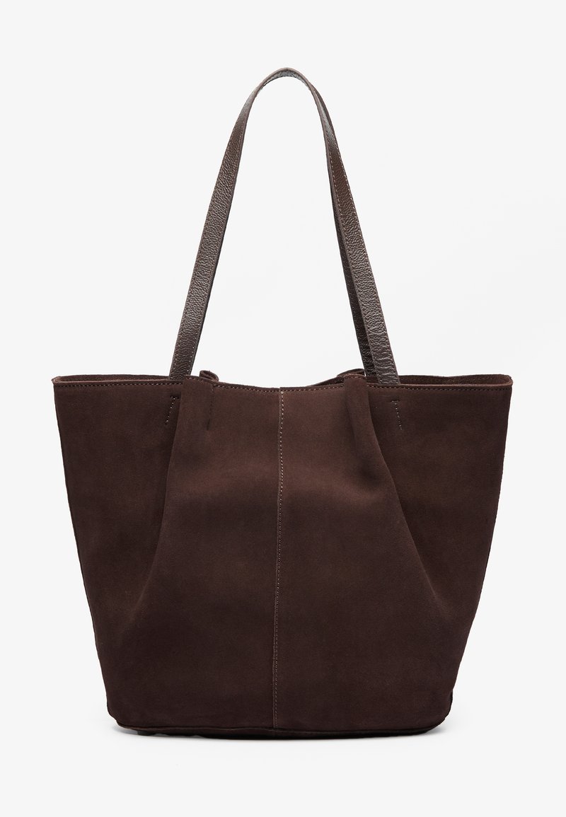 Brown suede tote bag with two textured leather handles. Features a simple, open-top design and subtle stitching along the front seam.