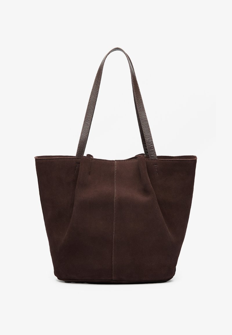 Brown suede tote bag with two textured leather handles. Features a simple, open-top design and subtle stitching along the front seam.