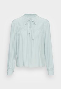 Blouse bleu clair à manches longues, col rond et détail de lien au col. Présente un tissu froncé pour un ajustement lâche et des poignets de manches à revers.
