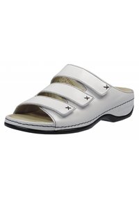 White leather sandal with three adjustable straps, open toe design, textured insole, and black rubber sole with white stitching accents.
