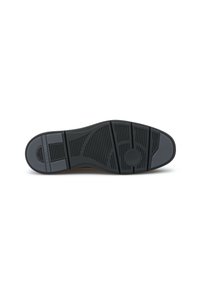 Sole di scarpa in gomma nera con superficie texture caratterizzata da scanalature e motivi per la trazione, inclusi un emblema circolare e dettagli del logo.