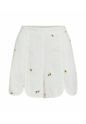 Hvite lin-shorts med bølgete kant og små gule sitronbroderier spredt over stoffet.