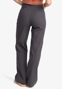 Black wide-leg trousers in a cotton blend, featuring a high waist, side pockets, and relaxed fit, with a smooth texture and simple design.