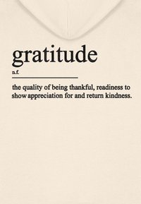 Cream-colored hoodie featuring the word "gratitude" in bold black text and a definition underneath, with a simple, soft texture.
