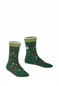 Calze di cotone verdi con polsini a coste bianchi, decorate con motivi festivi di omini di pan di zenzero, Babbo Natale, regali e fiocchi di neve in colori vivaci.