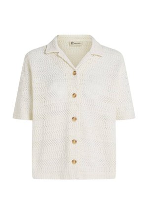 Balts īsroku tops ar apkaklīti, izcili tamborēts raksts un piecas apaļas koka pogas priekšpusē.